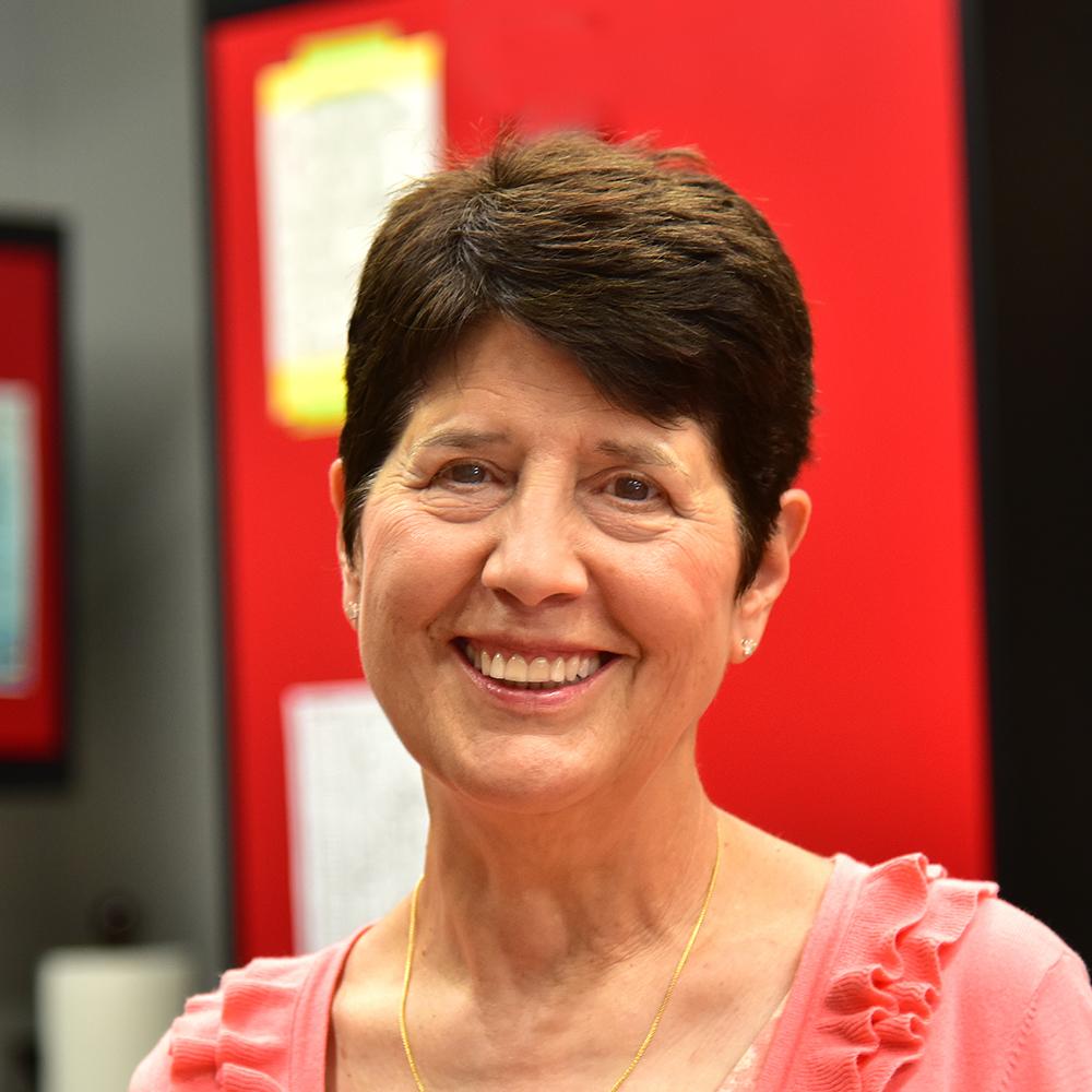 Cheryl Kloczko Woman with short brown hair wearing a pink shirt and smiling