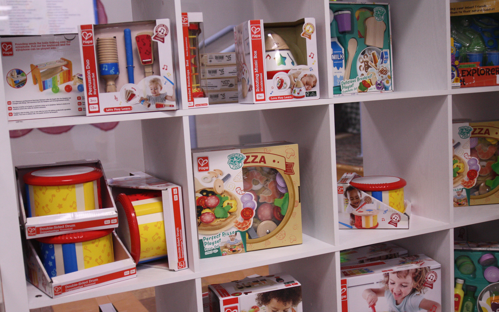 Wall of cubical shelves with toys on display.